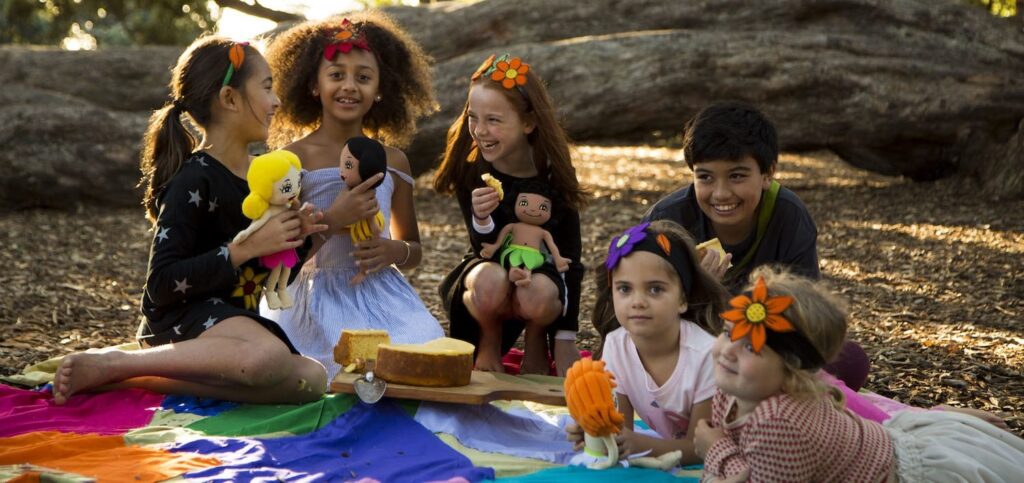 cultural diversity image of children frame various cultures sitting on a picnic blanket together